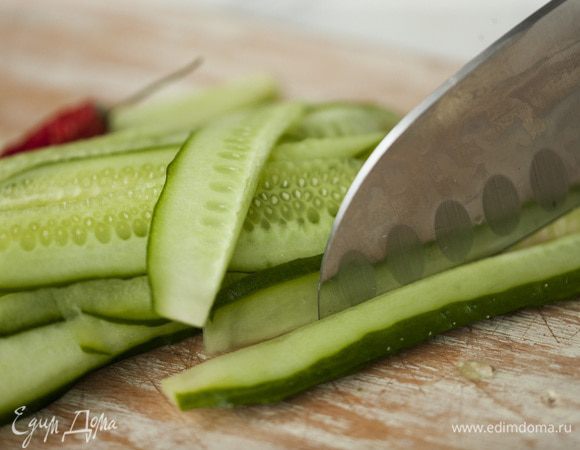 Огурцы нарезать вдоль длинными полосками. Полоски должны быть тонкие и прозрачные. Можно использовать нож для чистки картошки.