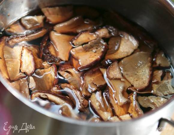 Сухие грибы залить горячей водой, дать постоять 30 минут, затем воду слить и сохранить, а грибы крупно порезать. 