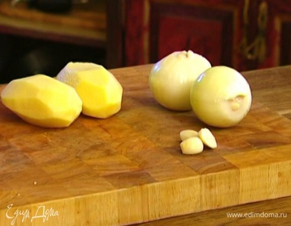 Овощи почистить. Картофель нарезать тонкими ломтиками, лук —полукольцами, чеснок — тонкими пластинками.