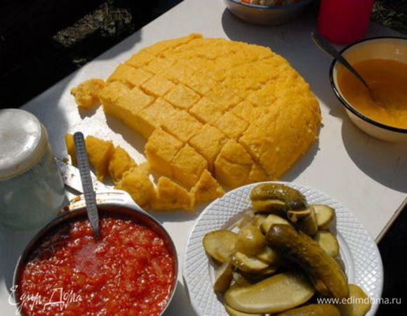 Когда мамалыга загустеет, ее отделяют смоченной в воде ложкой от стенок казанка и оставляют еще на некоторое время на огне, чтобы она пропеклась со дна и лучше отставала от казанка. Затем казанок хорошенько встряхивают несколько раз и опрокидывают мамалыгу на разделочную доску или на чистую скатерть, но не на блюдо, иначе мамалыга отпотеет и станет невкусной. Правильно сваренная мамалыга должна точно сохранять форму и очертания казанка и не разваливаться при вытряхивании. Затем мамалыгу режут на куски суровой ниткой или деревянным ножом.