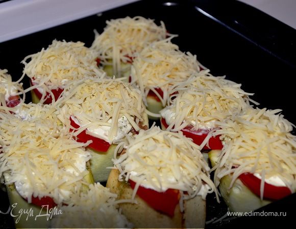 Наполняю фаршем шайбы, сверху кладу дольку помидорки, солю, перчу и кладу маленькую ложечку сметаны, затем натёртый сыр. 