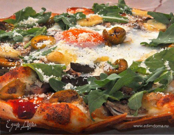 Готовую пиццу вынуть из духовки, немедленно посыпать свежей рукколой и крошкой пармезана, слегка сбрызнуть оливковым  маслом, поперчить и подать к столу.