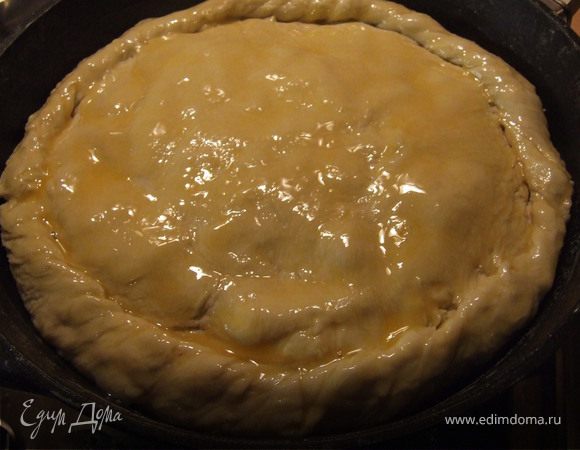 Вторую часть теста раскатываем и накрываем пирог, скрепляем края и смазываем желтком.