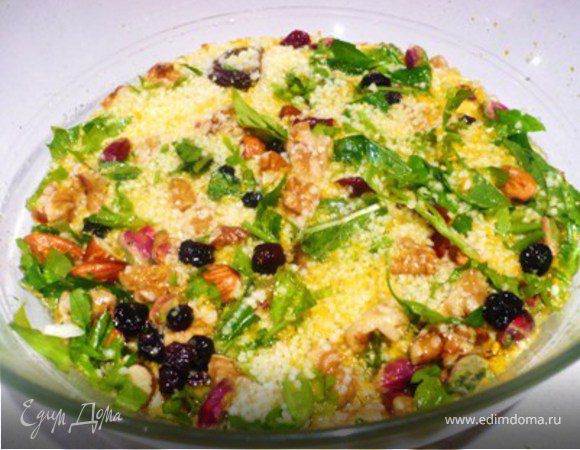 Перемешать цедру, сухофрукты, орехи, зелень и кус-кус.  Чуточку посолить.  Залить кипятком и дать постоять 15 минут. Кус-кус впитает всю жидкость. 
