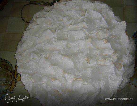 Заранее испечь корж из безе. Противень выстелить пергаментом, обрисовать форму, в которой будет выпекаться корж, выложить безе по контуру,  вытягивая пиками. Высушить в духовке.