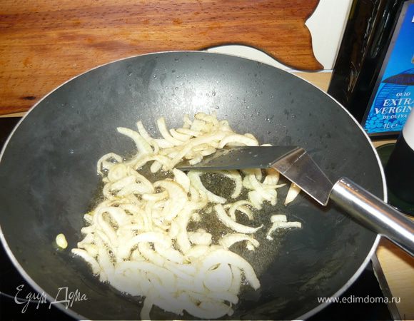 В сковороде разогреть оливковое масло, бросить туда зубчики чеснока, предварительно раздавленные плоской стороной ножа. Как только чеснок станет золотистым, убрать его. 
В этом масле обжарить фенхель, добавить кальмары. Обжаривать их в течение 1 минуты, интенсивно помешивая. Добавить сок апельсина с вермутом, тушить вместе не больше 1 минуты, чтобы кальмары не стали жесткими.