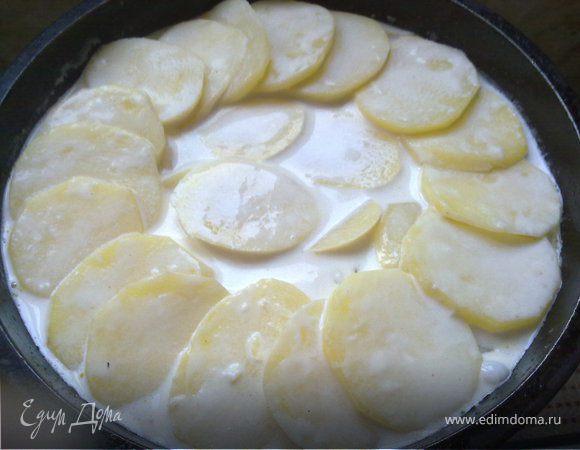 Натираем нашу форму для запекания чесноком, разрезанным пополам , и смазываем сливочным маслом. И аккуратно, слоями "по кругу" выкладываем картофель (он выкладывает в два слоя), чуть солим. Заливаем смесью, в которой он варился, и отправляем в предварительно разогретую до 170 градусов духовку на двадцать минут.