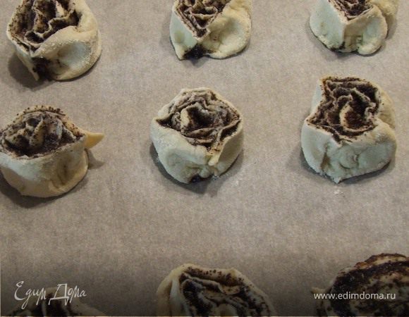 Тесто раскатать. Маковую начинку развести в 70 мл. воды и равномерным слоем размазать по  тесту.Тесто закатать рулетом, нарезать на части толщиной 1-2 см. и выложить на противень, покрытый пекарской бумагой.