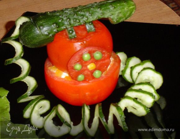 Когда все части "телефона" готовы приступаем к сборке "аппарата". Для этого на большую половинку помидора с начинкой укладываем меньшую, устанавливаем "диск набора", укладываем рычаги, вставляем в надрез "трубки" спираль, укладываем "трубку" на "рычаги", а второй конец спирали прячем за "телефоном".