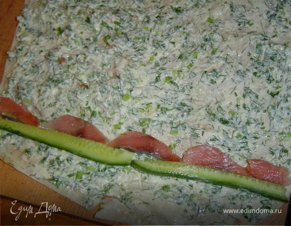 На лаваш укладываем слоями огурец, горбушу и делаем один оборот.