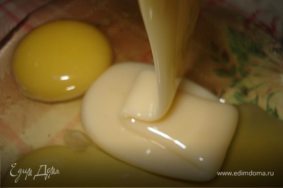 В чашку разбить яйца, добавить сгущённое молоко, ванильный сахар, соль и масло, всё перемешать.