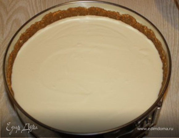 Творог сбиваем блендером или миксером с сахаром, яйцами и сметаной.Получившийся творожный крем выкладываем в форму на печенье-молочную смесь. 