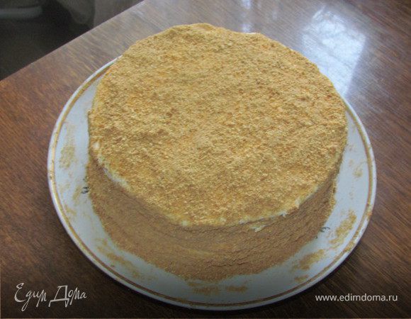 Мед растереть с сахаром и яйцами, добавить масло и гашеную соду. Поставить на слабый огонь или водяную баню и мешать до полного растворения и получения однородной массы. Дать массе немного остыть и частями всыпать просеянную муку. Вымесить гладкое тесто. Скатать в колбаску и разделить на 8 равных частей. Испечь 8 коржей. Выпекать при 180 градусах минут 5 (смотреть по готовности, коржи очень тонкие и пекутся быстро, не надо их передерживать и пересушивать, как только корж начал румяниться, его можно вынимать). Каждый готовый корж пока он еще горячий ровно обрезать с помощью тарелки нужного Вам диаметра. Обрезки пойдут на украшение нашего торта. Сделать крем: взбить сметану с сахаром и яичным белком. Обильно промазать каждый корж кремом. Оставшиеся обрезки отправить опять в духовку и дать им хорошо зарумяниться, затем измельчить их в крошку с помощью блендера и обсыпать наш торт. Дать торту пропитаться при комнатной температуре часов 5. И можно наслаждаться чаепитием.