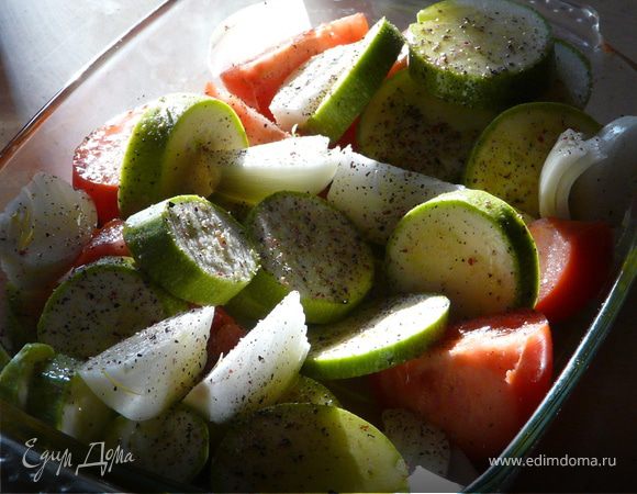 В огнеупорную посуду сложить порезаный кабачок, помидор, чеснок, сбрызнуть маслом и приправить. Поставить в духовку на 25 мин при 200С. 