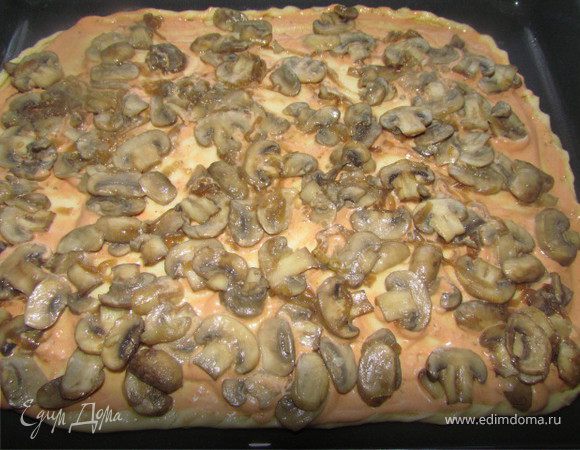 Шампиньоны нарезать тонкими ломтиками, лук полукольцами. Немного припустить грибы с луком на растительном масле (минут 5 максимум). Выложить грибы с луком на тесто.
