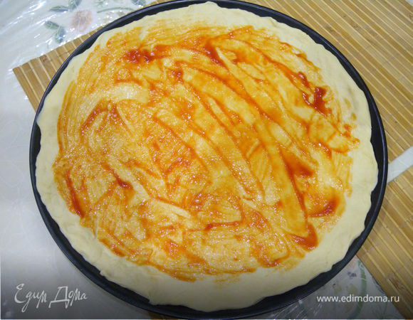 Смажьте томатной пастой или кетчупом, не доходя до краев 2 см.