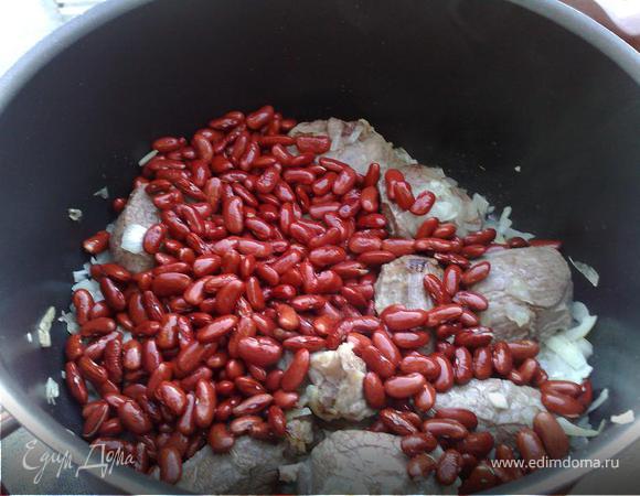 К мясу добавить нарезанный кубиками крупно лук.Добавить тмин( можно молотый).Обжарить.Залить кипятком.Соль перец по вкусу.Добавить фасоль.Сушеные лимончики разрезать пополам добавить в мясу( они придают блюду обалденный аромат!)