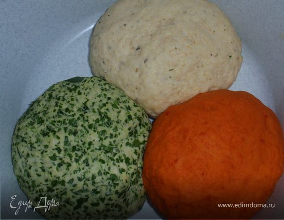 Разделить тесто на три части. В одну добавить измельченную зелень. Во вторую - паприку и мелко нарезанный перец чили. А в третью - сыр, натертый на мелкую терку, и прованские травы. Дать тесту постоять еще 40 минут.