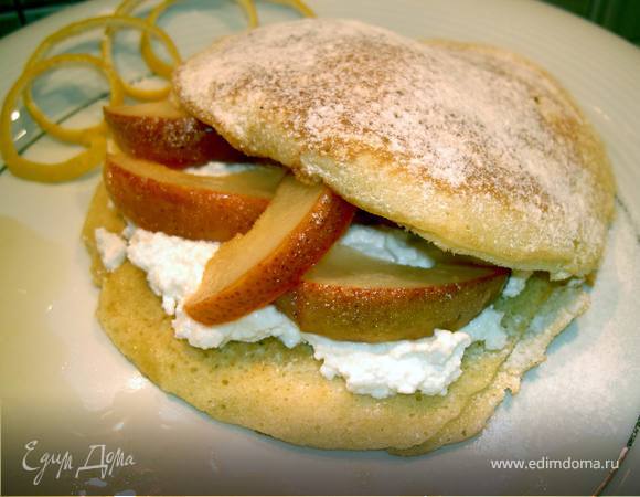 Разложить по 4 блинам сыр рикотта. Покрыть дольками груши, накрыть другим блином и посыпать сахарной пудрой. 
Разложить по 4 тарелкам с грушевым соусом.