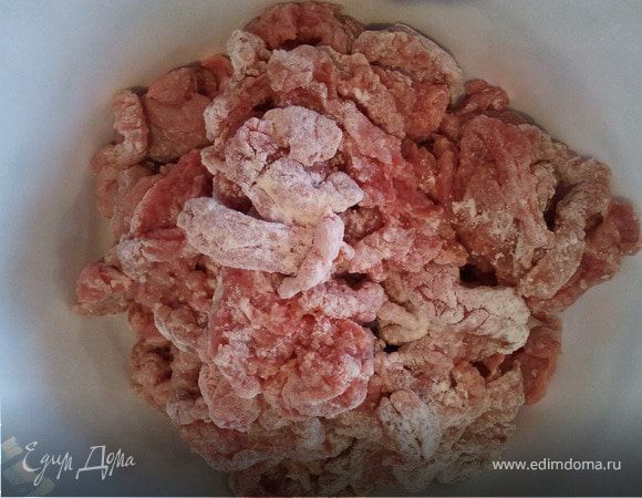 Обвалять нарезанное мясо в муке. Удобнее это делать небольшими порциями.