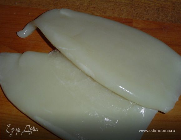 Кальмары отвариваем в соленой воде, охлаждаем и режем кубиками. Варим яйца и измельчаем их. Натираем сыр. Отвариваем рис. Смешиваем все ингредиенты и заправляем сметаной и майонезом, смешанных в равных частях. 
Для бокалов использовала редьку дайкон,Подкрасила пищевым красителем,имитируя налитое вино.Из красной редьки изготовила розы.
Вот и готов наш салат. Быстро, просто, вкусно!