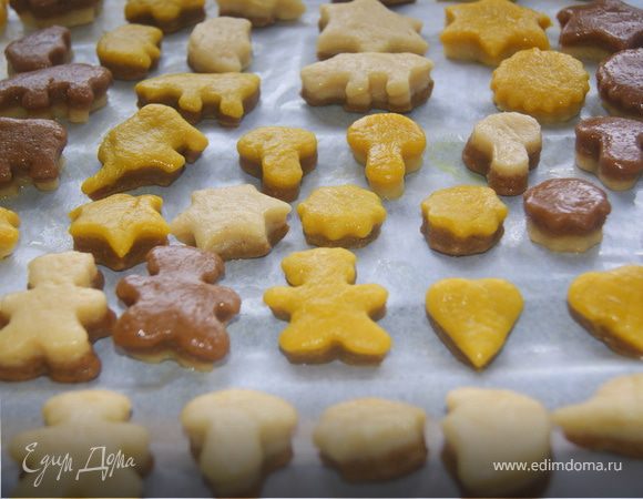 Тонко раскатать тесто каждого цвета и положить на друг друга в 2 слоя, по цветам можно делать как угодно. Формочками вырезать печенье. Уложить на противень бумагу для запекания и выложить печенье.