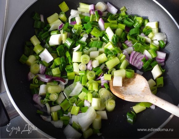 Тем временем зеленый лук порезать кольцами и подрумянить вместе с оставшимся репчатым луком на масле.
