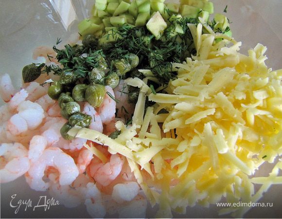 Пока корзинки выпекаются готовим салат из креветок, порезанного кубиками авокадо, укропа, каперсов и натертого твердого сыра. Все ингредиенты тщательно перемешиваем.