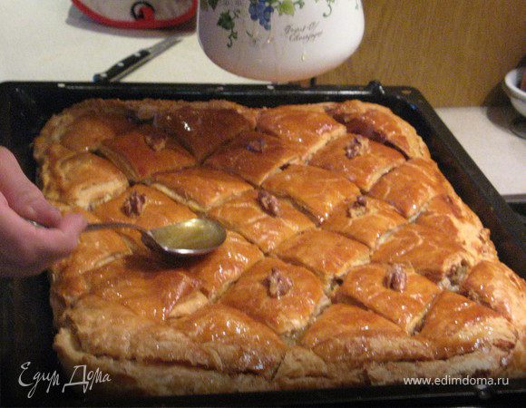 Вытаскиваем нашу румяную красавицу из духовки, даем немножко отстояться, "подсесть" и подостыть. Затем углубляем разрезы  и заливаем ее половиной нашего горячего сиропа, в разрезы побольше, чтобы лучше пропиталась. Настаиваться должна Пахлава как минимум 20 минут, потом можно разрезать и подавать на стол.
