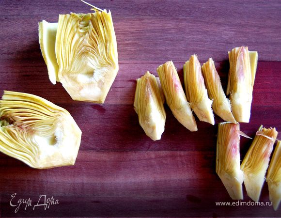 Луковицу мелко нарезать и разделить на две части. Половину поместить в сковороду с оливковым маслом и слегка обжарить на среднем огне. Артишоки тонко нарезать.