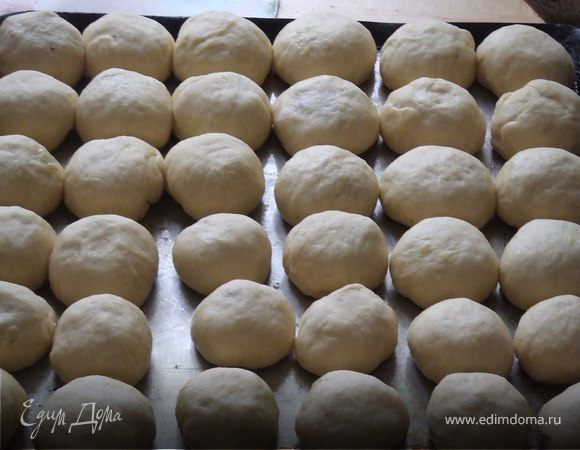Мягкое, подошедшее тесто разминаем и оставляем на 10 минут. Делим на небольшие кусочки, в руках формируем лепёшку - тесто очень мягкое, и кладём начинку, защипываем края, смазываем низ и бока растопленным маслом и рядышком друг к другу выкладываем в противень. Ставим для подъёма, пока будет греться духовка (где-то 200 градусов). Смазываем маслом и выпекаем минут 20 до золотистой корочки.