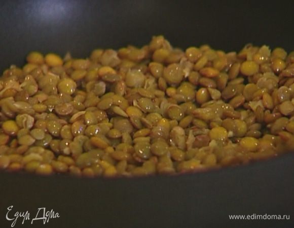 Разогреть в сковороде оливковое масло и слегка прогреть чечевицу на медленном огне.