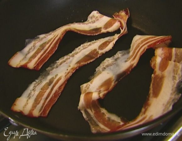 Бекон обжарить в разогретой сухой сковороде, затем выложить на бумажное полотенце, чтобы убрать излишки жира.