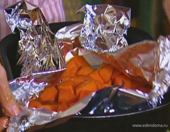 Противень застелить пищевой фольгой так, чтобы свешивались края, выложить тыкву и прикрыть ее краями фольги. Отправить тыкву в разогретую духовку и запекать до готовности.