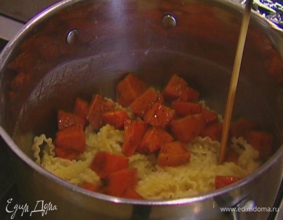 Вернуть макароны в кастрюлю, где они варились, добавить запеченную тыкву, перемешать. 