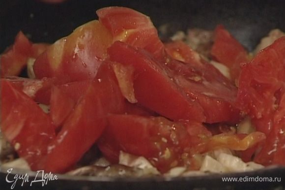 Оставшиеся помидоры нарезать крупными дольками и тоже добавить в сковороду.