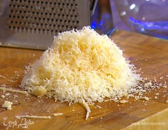 Желтки слегка взбить вилкой и соединить с большей частью натертого сыра.