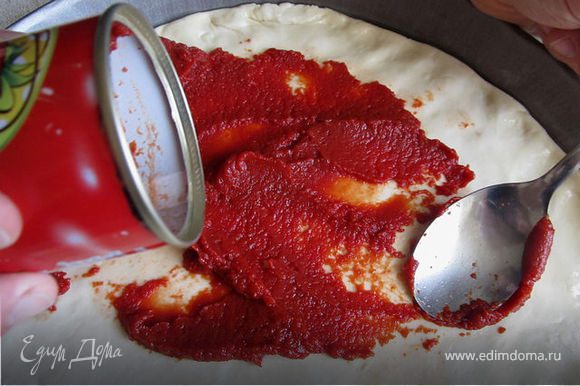 На тесто ровным слоем выложить томатную пасту. Мне нравится "Помидорка", не кислая и вкусная!