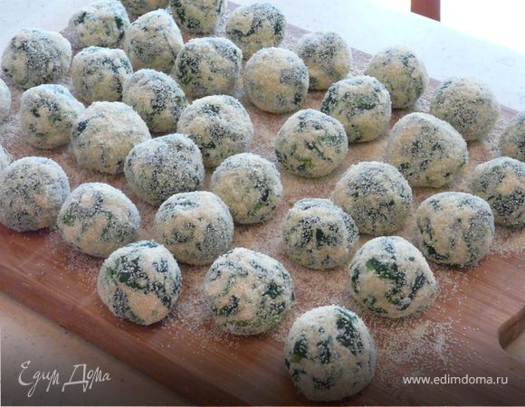 Смешать рикотту, сыр, яйца, шпинат (оттаявший, подсушеный и порезаный, или если свежий, ошпареный кипятком), добавить муку. Скатать шарики, размером с каштан, обвалять в манке и сложить на доску, посыпаную манкой, дать им немного постоять.
