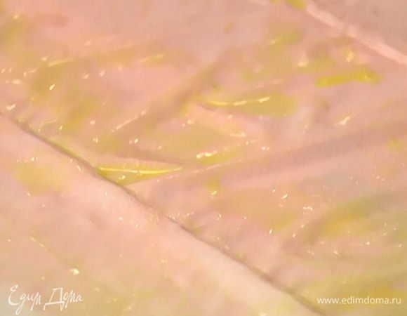 Смазать каждый лист фило предварительно размягченным сливочным маслом, сложить пополам и разрезать на две части. 