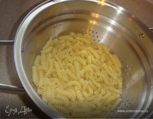 Сварить пасту в достаточном количестве подсоленной воды, не доварив 1 минуту.  Готовую пасту откинуть на дуршлаг, оставив пару половников воды, в которой она варилась на случай, если паста будет не достаточно влажной. 