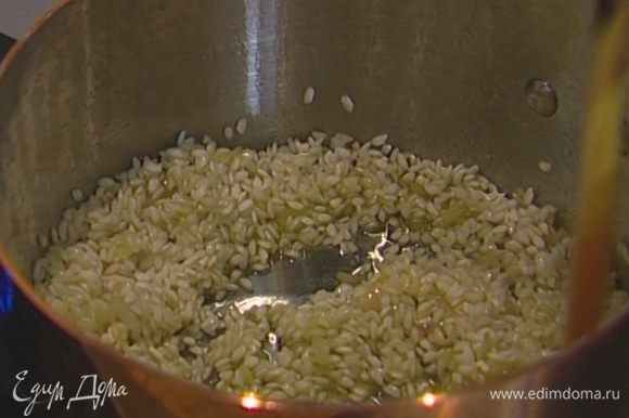 Всыпать в кастрюлю рис, сделать тостатуру: прогревать рис, постоянно помешивая, в течение 1‒2 минут, пока зерна не станут прозрачными.