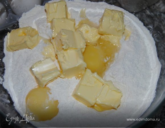 Масло нарезать кубиками, смешать с просеянной мукой, яйцом, желтком и солью.