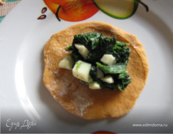 Варёные яйца очистить,мелко порубить и смешать с нарезанным шпинатом,посолить,поперчить.Тесто скрутить в жгут,нарезать кусочками,обвалять в муке и раскатать кружочки.В середину каждого кружка выложить начинку,