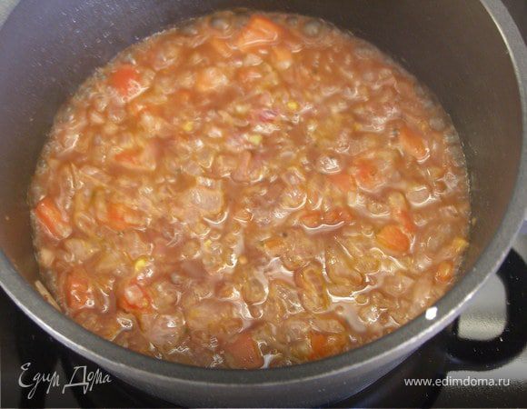 К луку добавить вино и помидор. Дать провариться минут 5 на сильном огне.