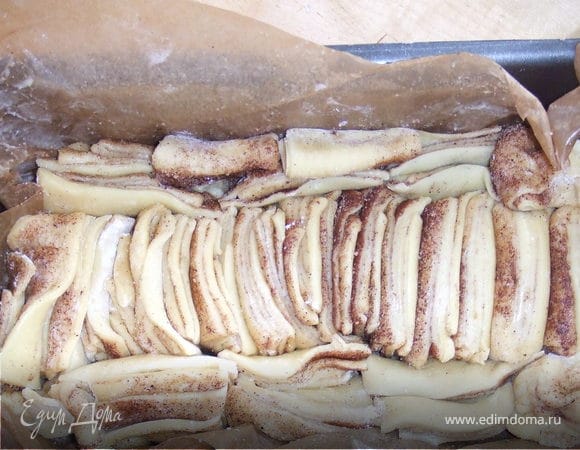 Аккуратно сложить кусочки теста в прямоугольную форму для кекса, выстланную бумагой для выпечки. Накрыть пленкой и оставить подходить еще минут 40.
