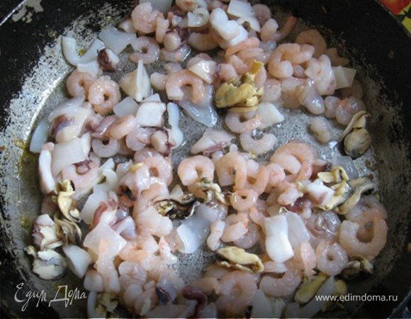 На сковороду выкладываем "морской коктейль" и на огне чуть меньше среднего выпариваем из него большую часть жидкости. Посыпаем молотой паприкой, высыпаем рубленный чеснок, перемешиваем и выкладываем в суп. К тому времени картофель уже почти готов.