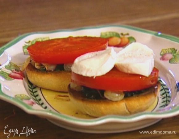 На каждый ломтик хлеба положить немного оливковой заправки, посолить, поперчить, затем выложить жареный лук, кружок помидора и кружок моцареллы.