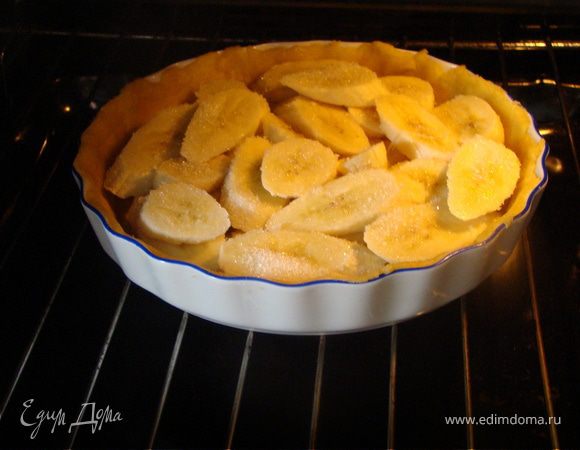 Достаем через 20 минут, прокалываем вилкой тесто. Выкладываем сверху порезанные бананы и присыпает сверху сахаром, совсем чуть-чуть, чтобы не было потом сладко. 
Ставим в заранее разогретую духовку до 180 градусов на 20-25 минут. 