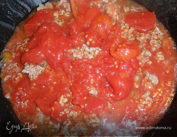 Когда фарш поменяет цвет добавим томаты с соком. Я купила цельные и порезала их, можно просто купить измельченные. Добавим приправы, накроем крышкой и оставим томиться на 30 минут.